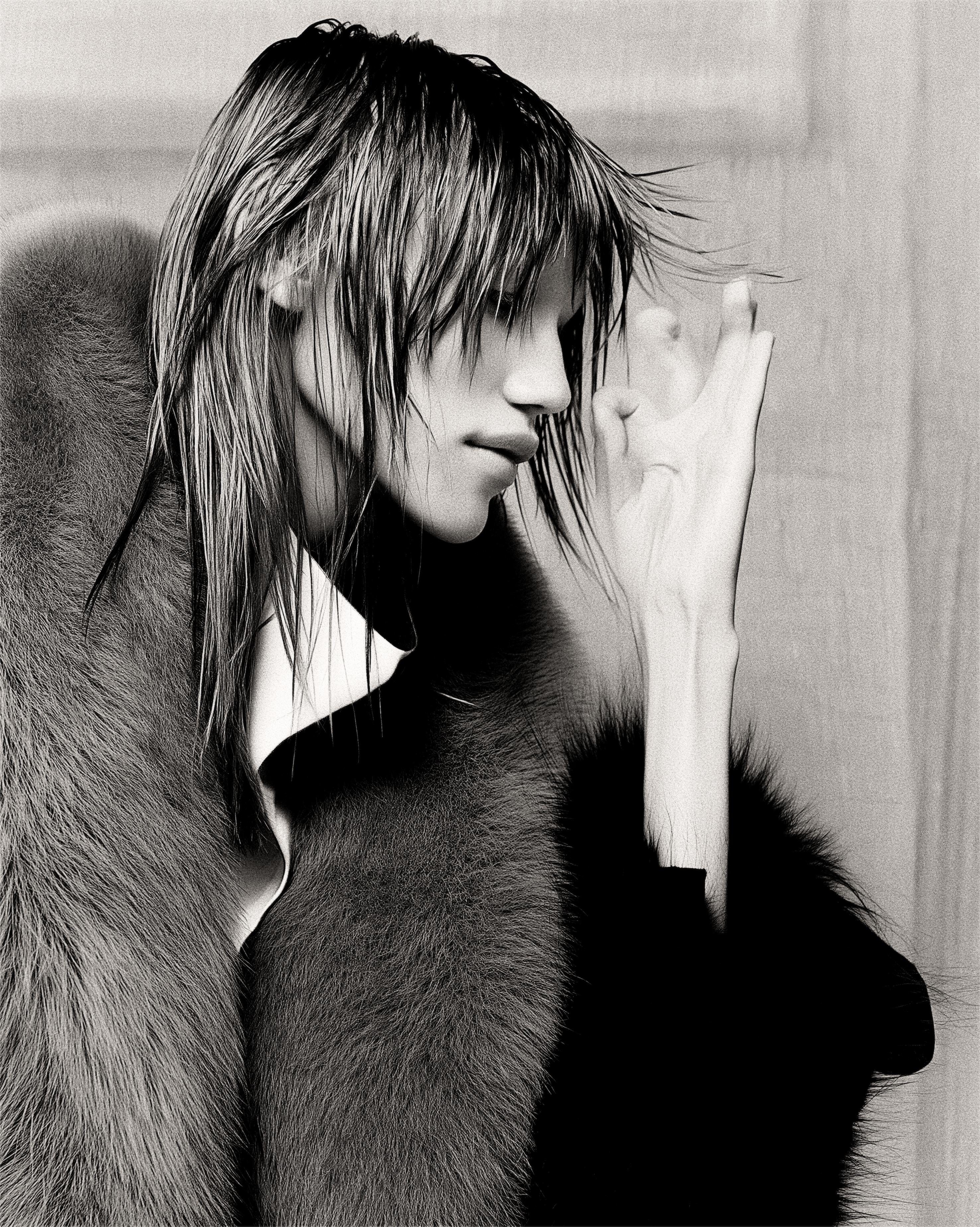 A profile in a fur stole, wet-set hair, hand raised
