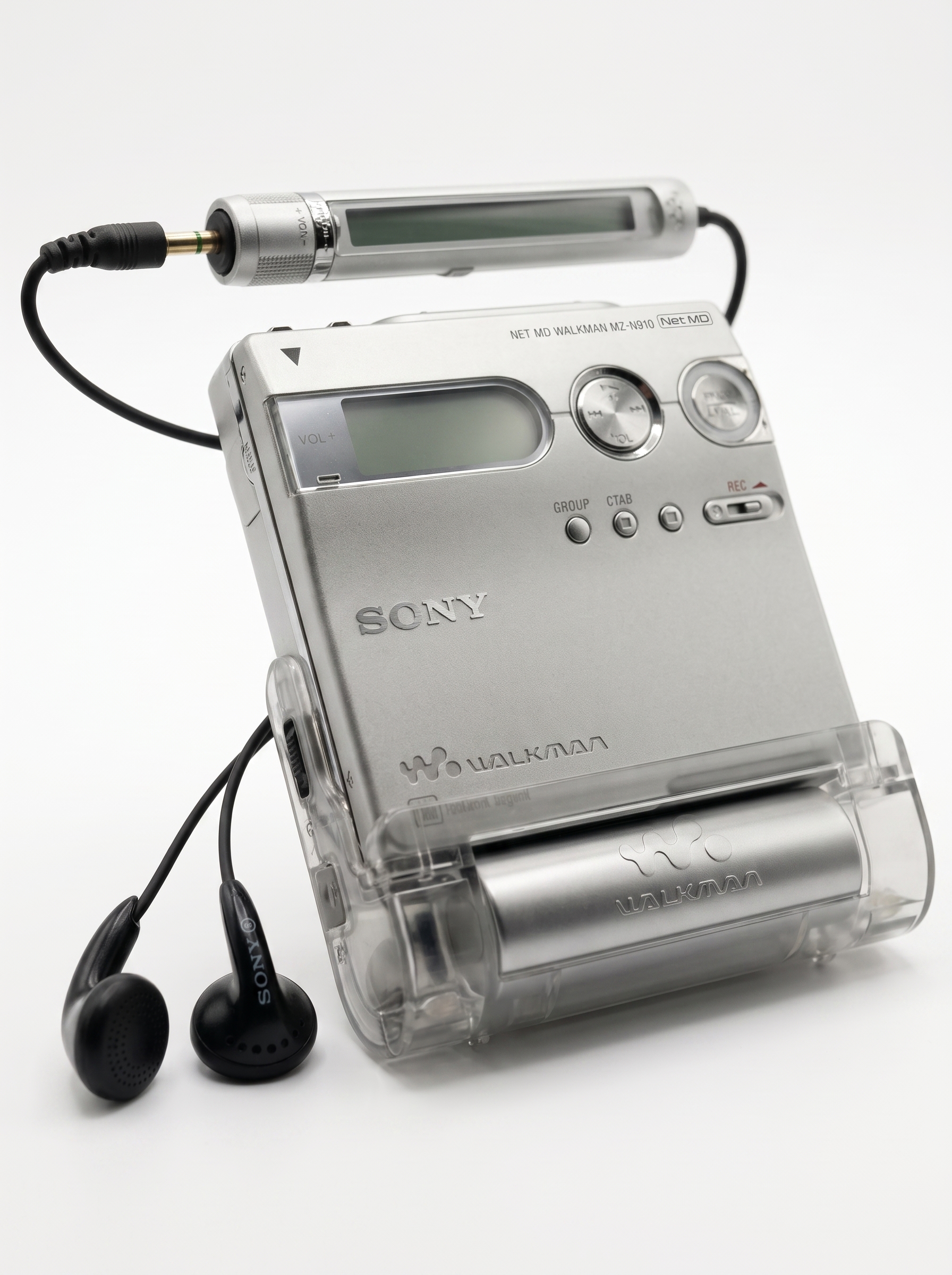 A Sony MiniDisc Walkman in its transparent case, wired earbuds coiled beside it