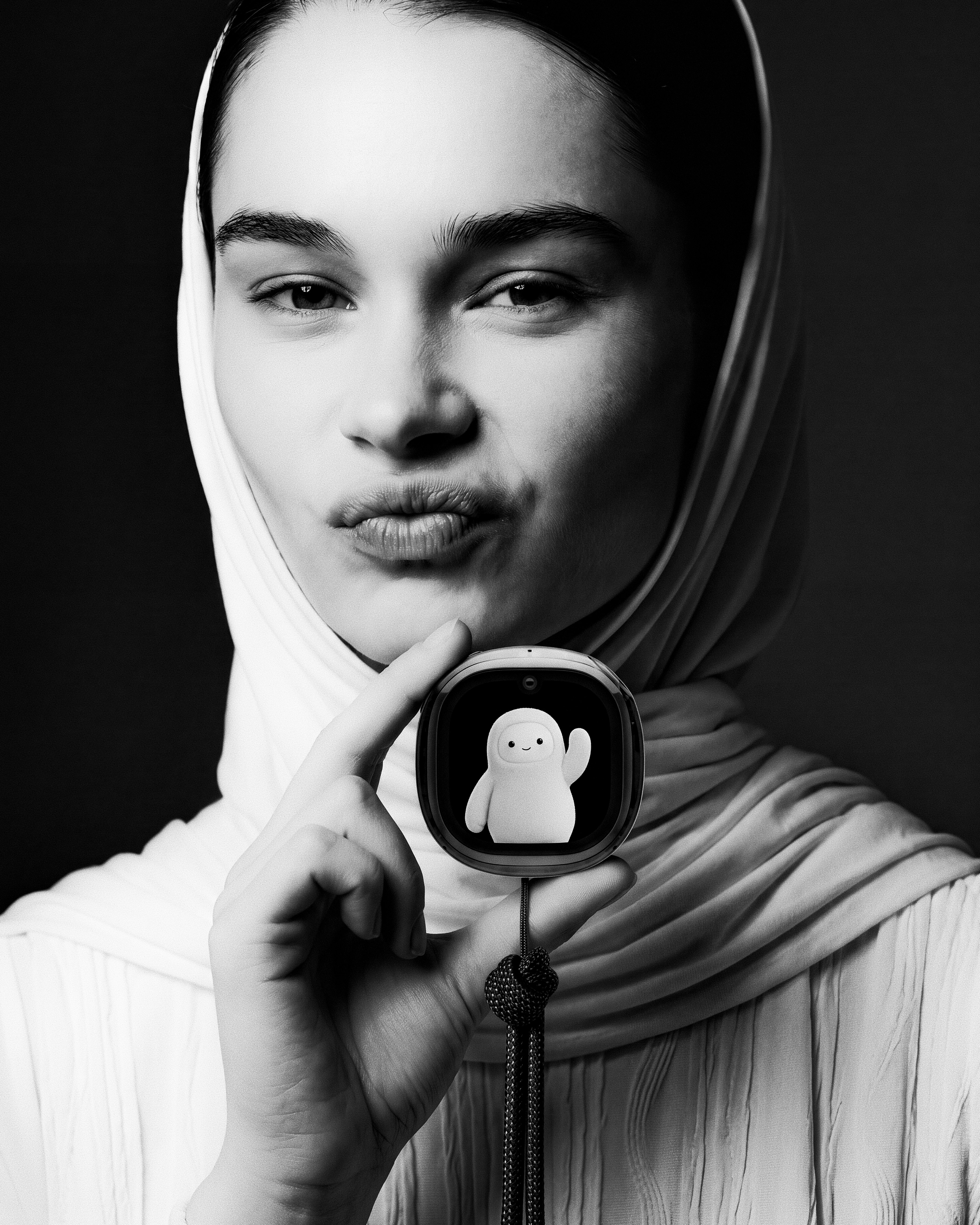 Editorial black-and-white still holding the Muse Charm.
