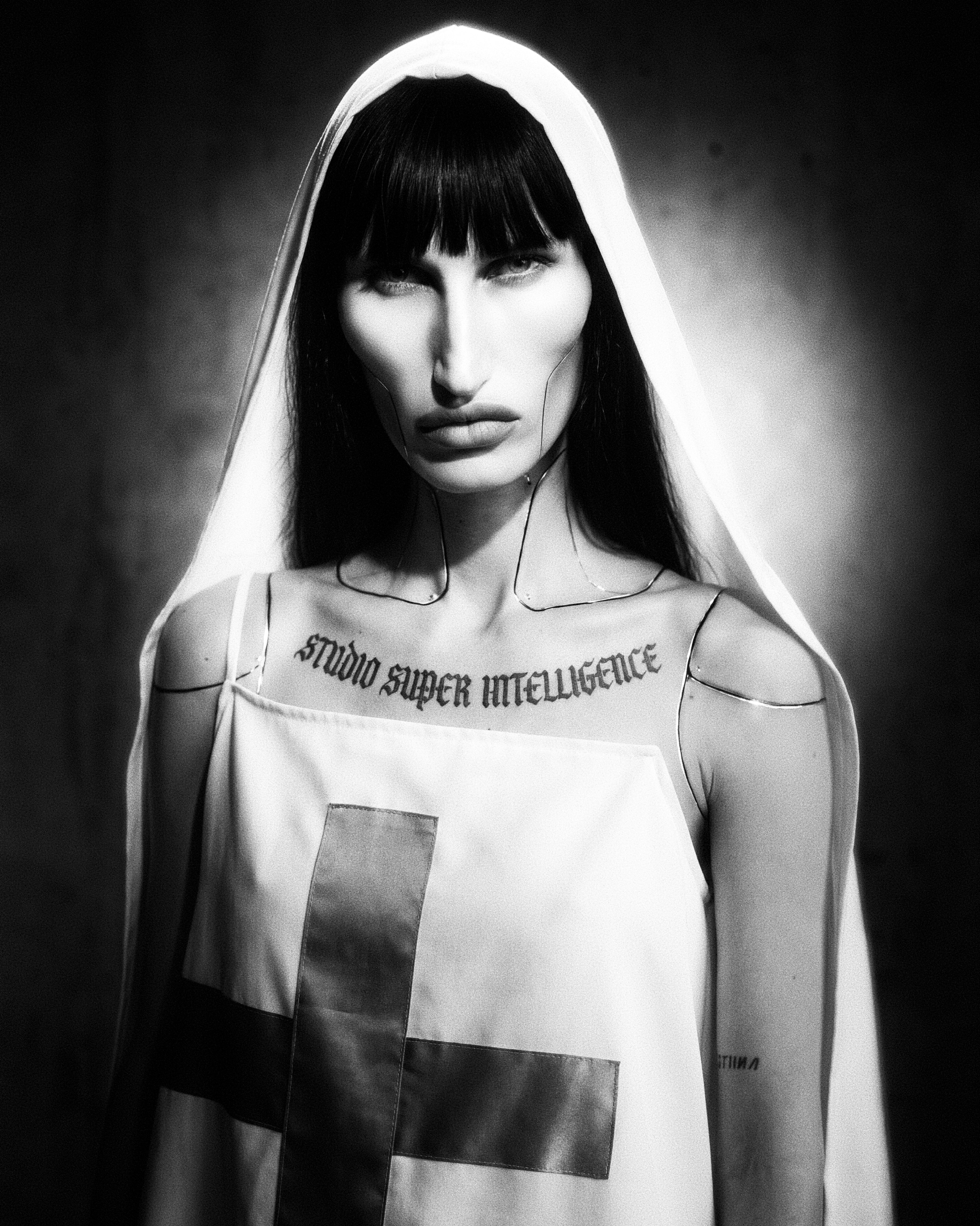 Confession Turk Plate 02 — articulated gynoid confessor in a white veil and cross habit with Studio Super Intelligence blackletter collar inscription.
