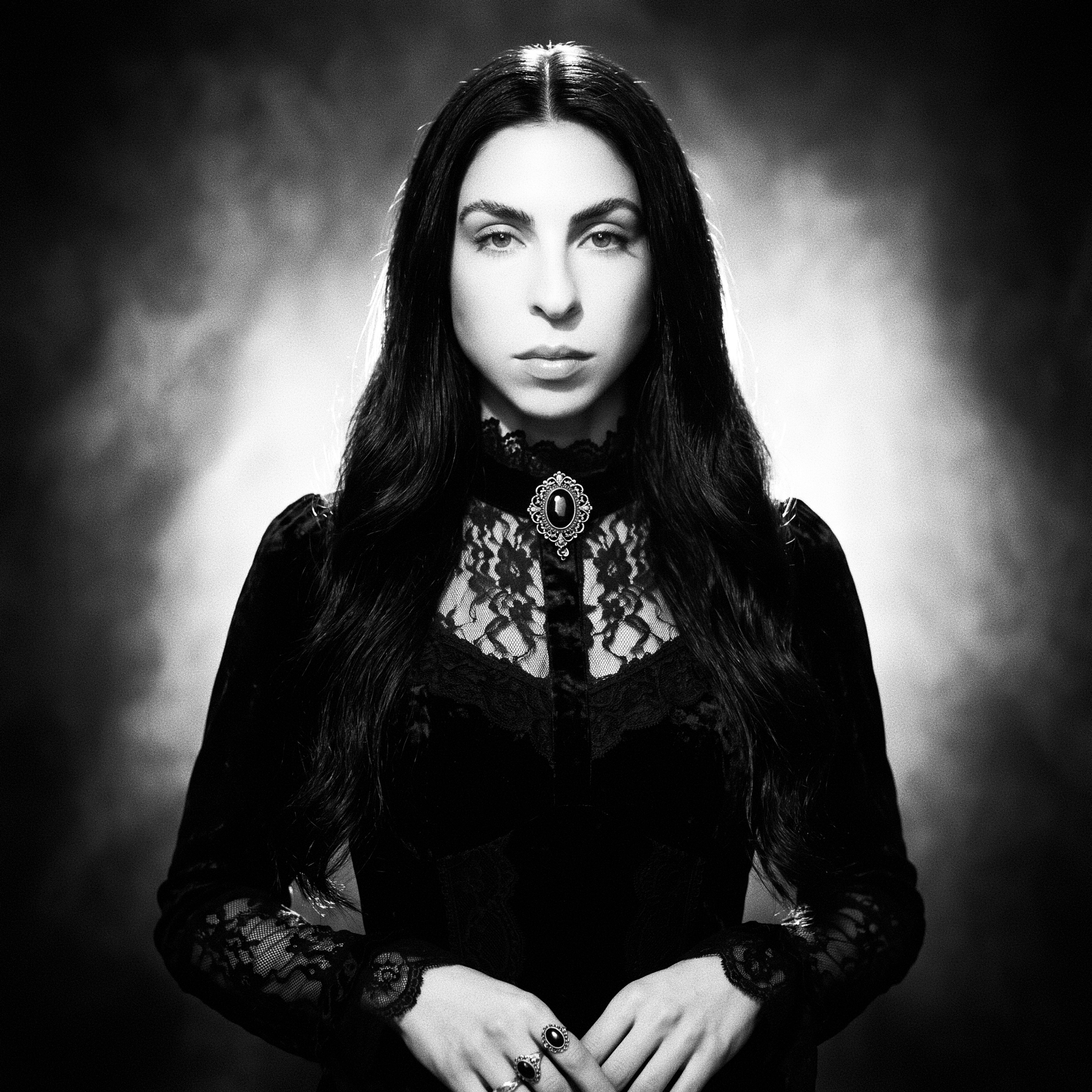 Leah McCarthy — monochrome portrait in high-neck Victorian black lace with an onyx cameo brooch.